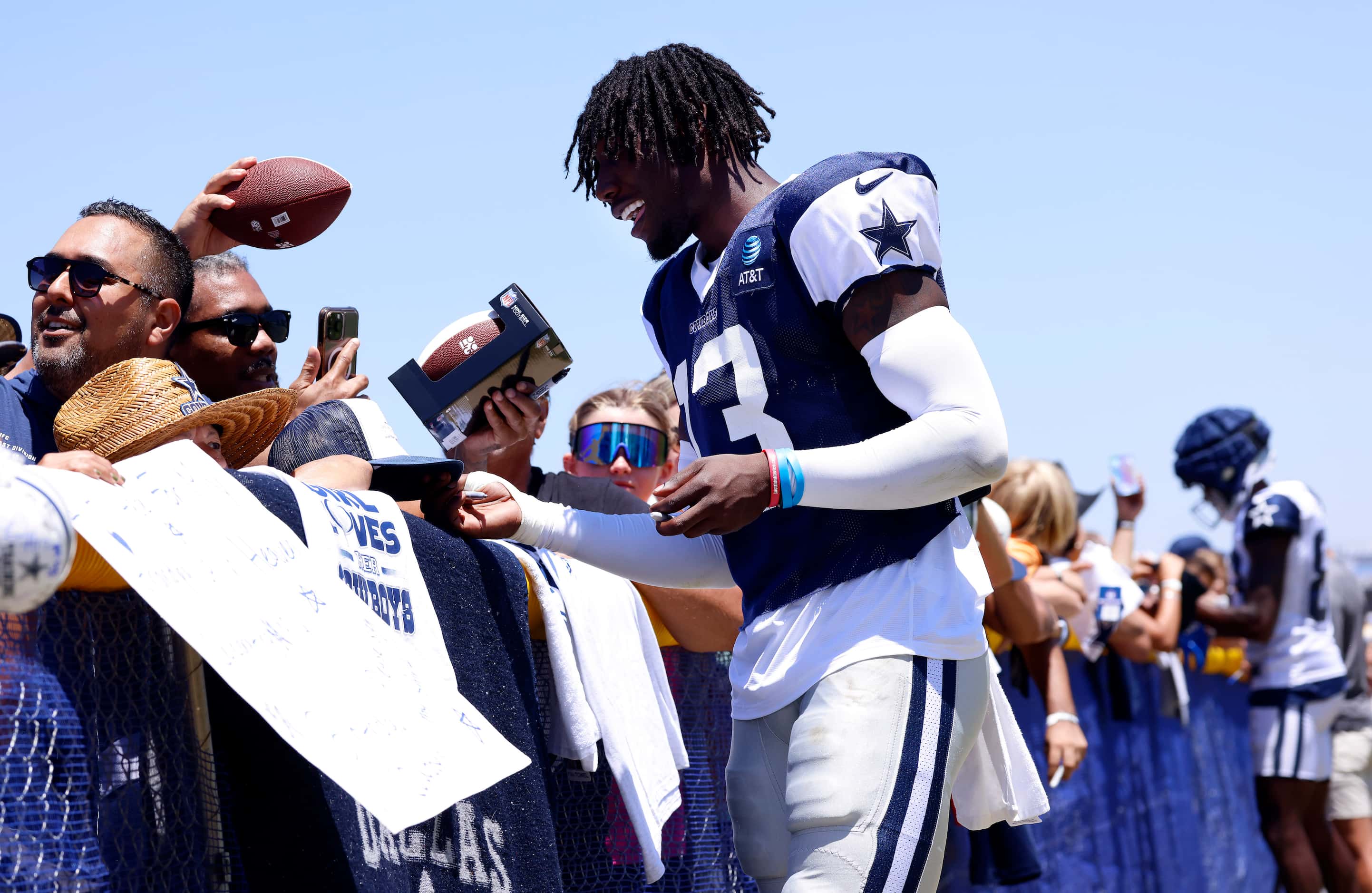 Dallas Cowboys linebacker DeMarvion Overshown (13) signs autographs for fans following...