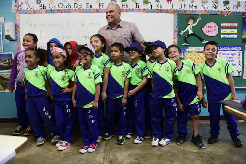 Students pose for a photo with Major League Baseball player Ivan 'Pudge' Rodriguez, who was...