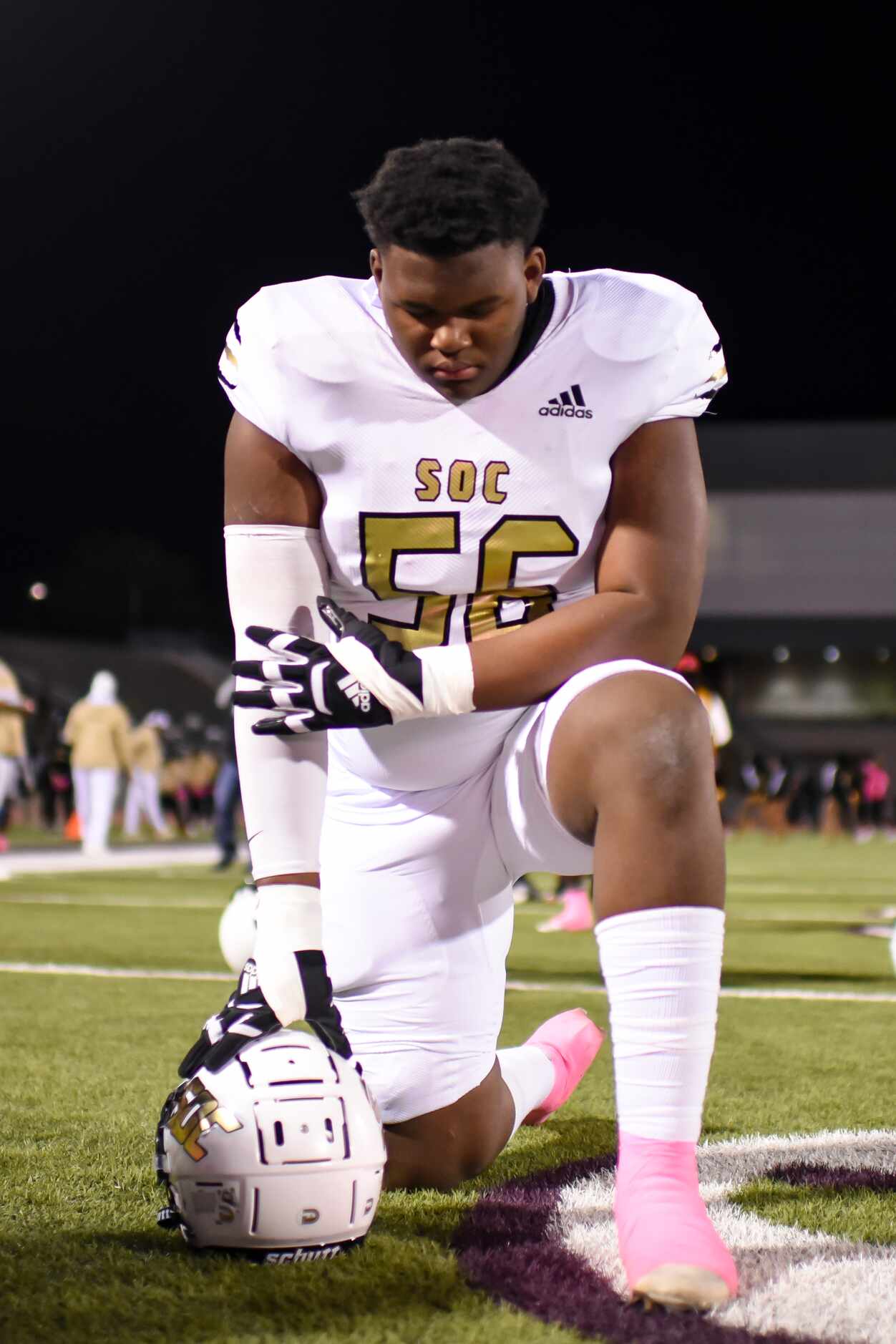 South Oak Cliff junior Norda Stoker (56) bows his head in prayer prior to the start of the...
