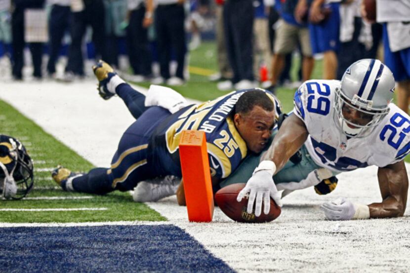 Dallas Cowboys running back DeMarco Murray (29) reaches out to score a touchdown as he is...
