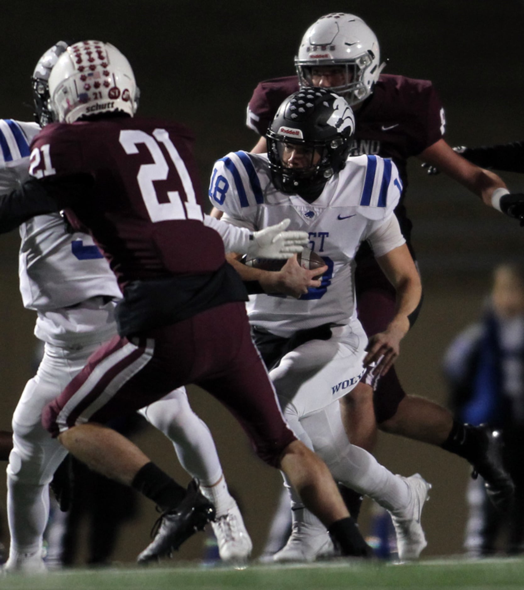 Plano West quarterback Greg Draughn (18) finds a running lane as he weaves his way into the...
