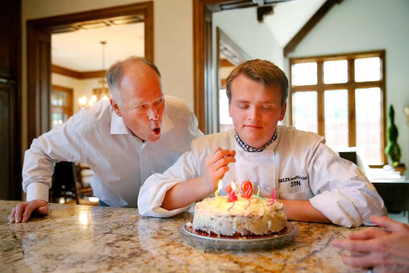 Clay Heighten helps his autistic son Jon Heighten blow out the candles on his 19th birthday...