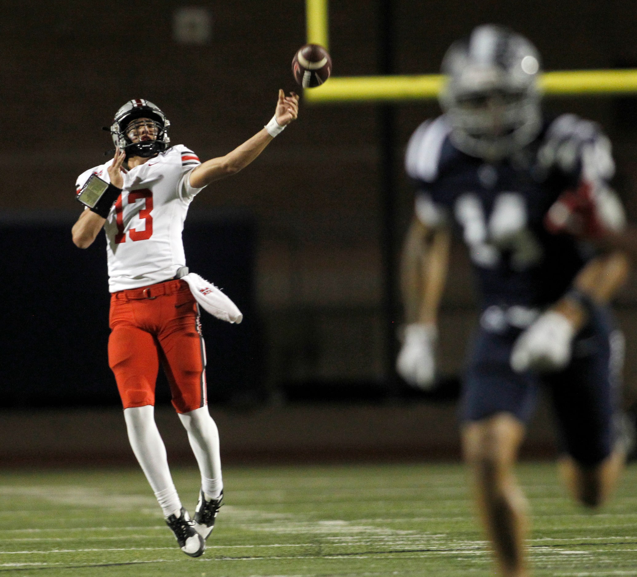 Flower Mound Marcus quarterback Colton Nussmeier (13), left, launches a long pass downfield...