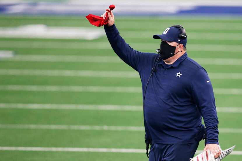 Dallas Cowboys head coach Mike McCarthy challenges the spot of the ball on a run play in a...