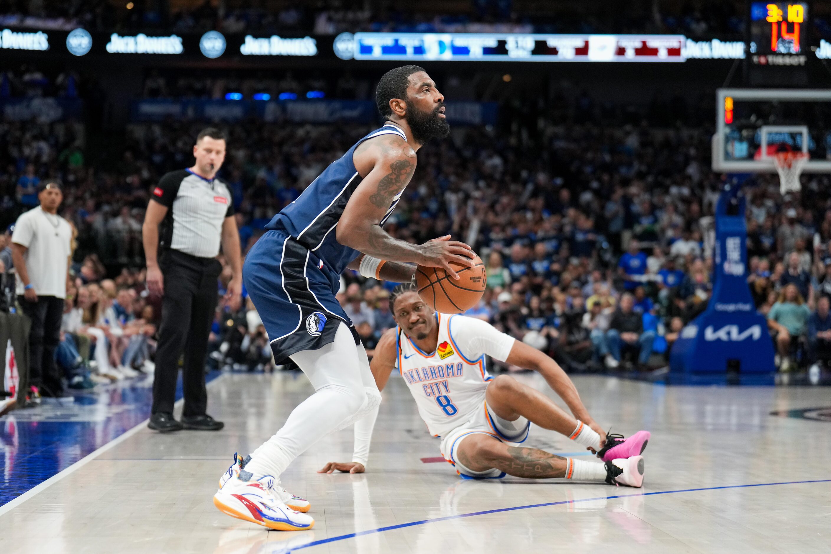 Dallas Mavericks guard Kyrie Irving (11) sets up to sink a 3-pointer past fallen Oklahoma...