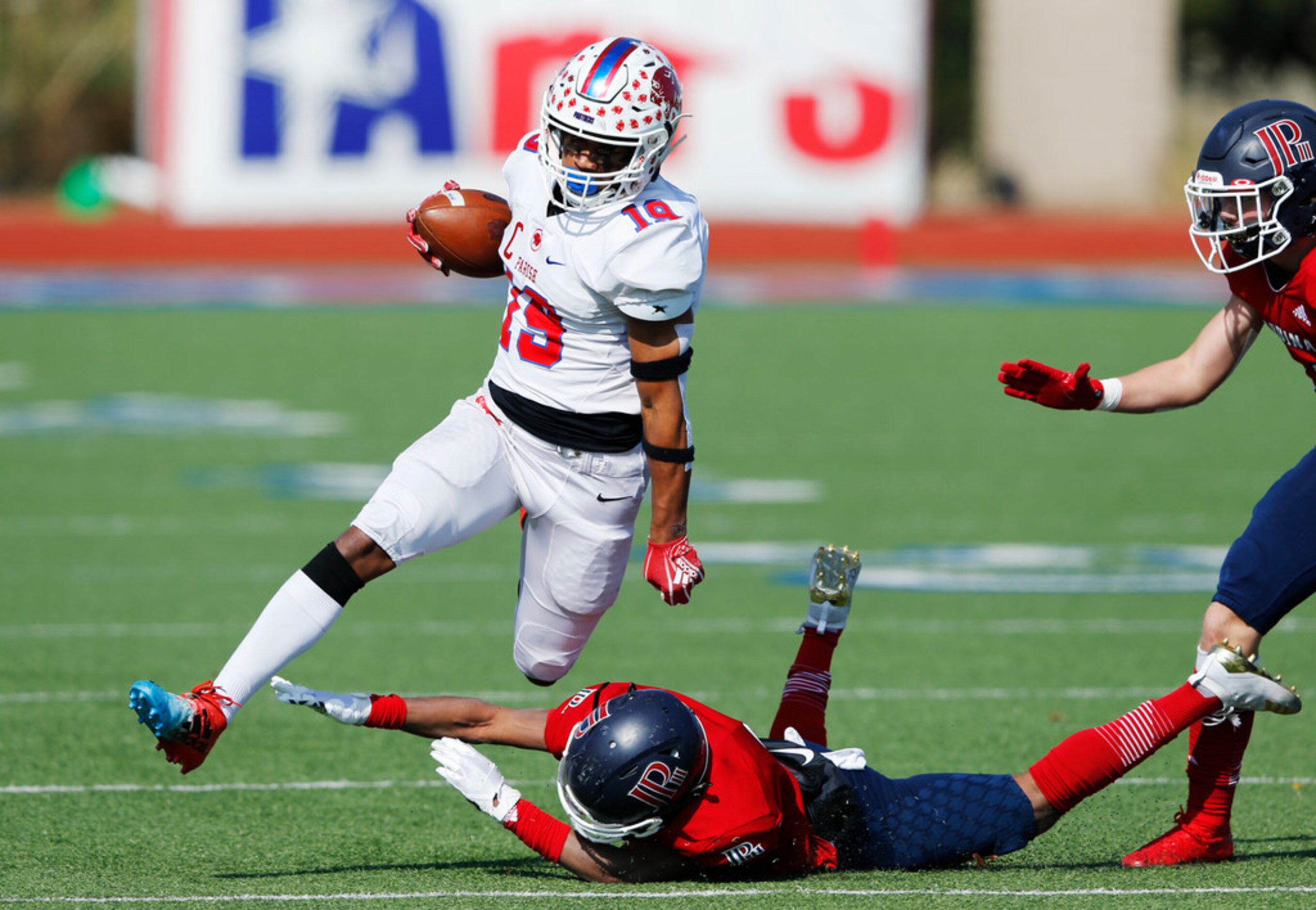 Parish Episcopal's Kaleb Culp (19) leaps over Plano John Paul II's Cameron Peters (8) during...