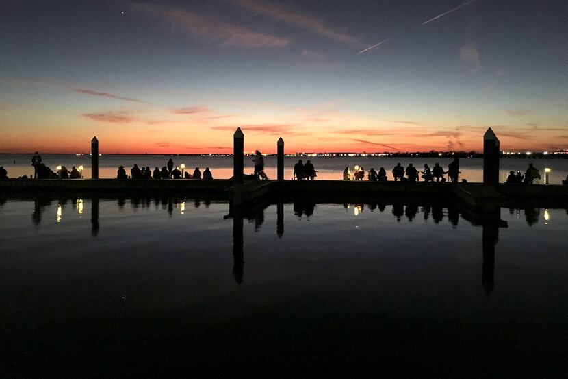 People lined the harbor docks to watch a gorgeous sunset over Lake Ray Hubbard, in Rockwall,...
