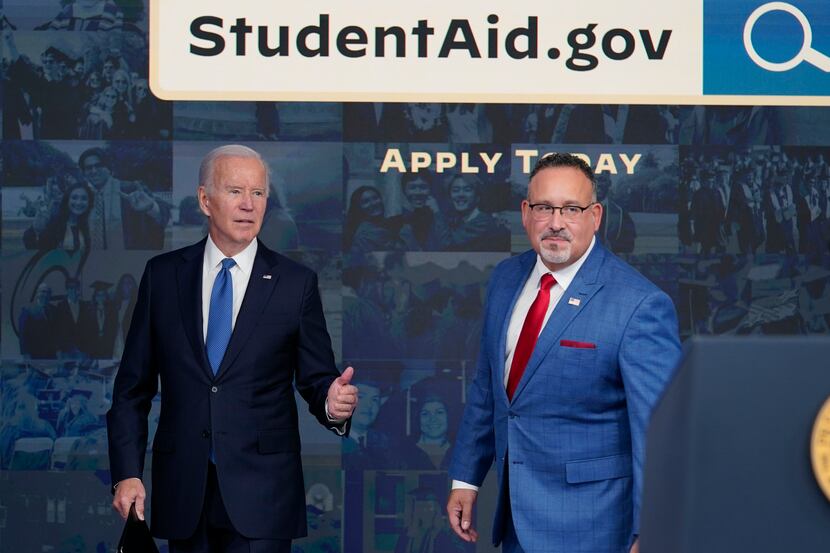 FILE - President Joe Biden answers questions with Education Secretary Miguel Cardona as they...