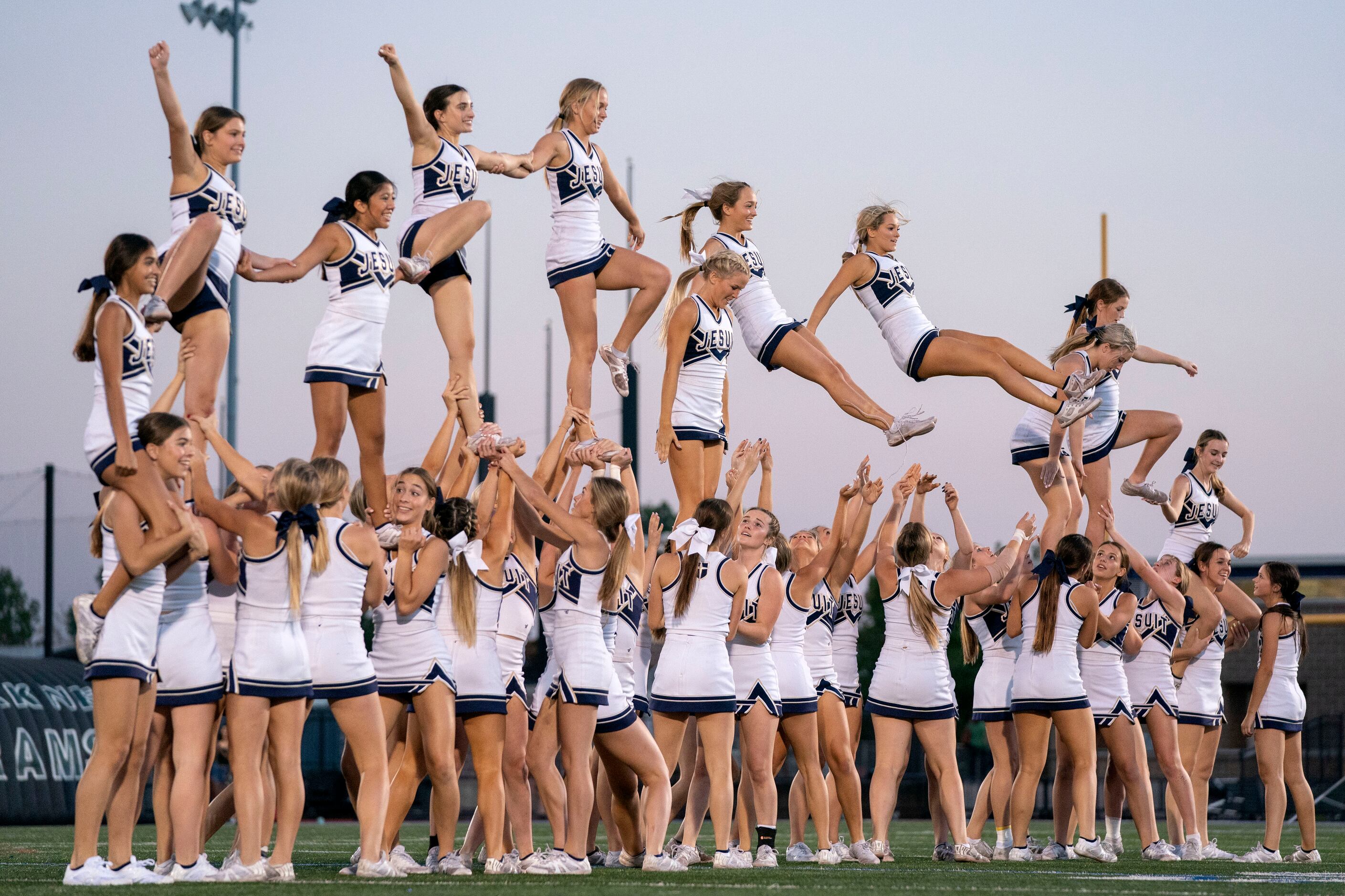 The Jesuit cheerleaders perform before a high school football game against Richardson...