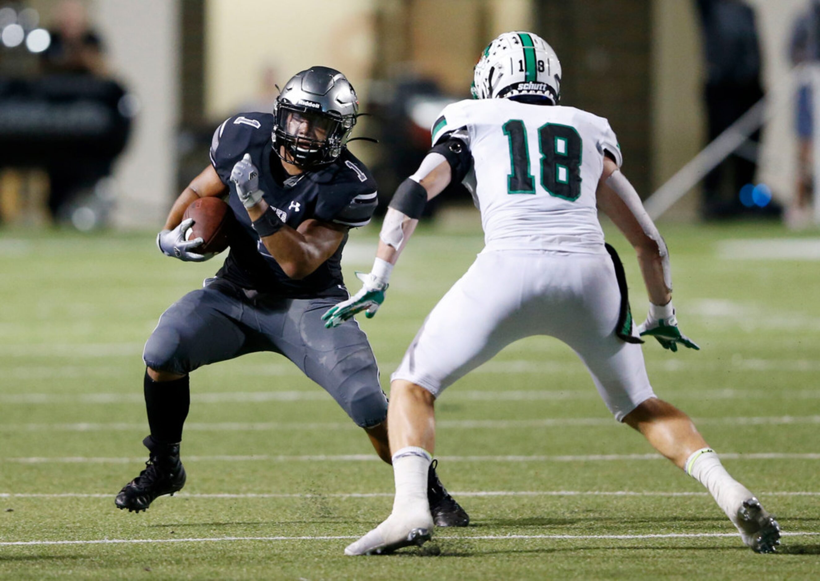 Denton Guyer's Kaedric Cobbs (1) attempts to shake Southlake Carroll's Preston Forney (18)...