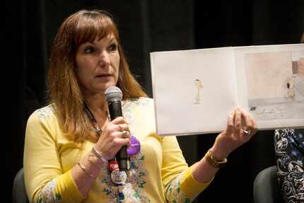 Jo Giudice, director at Dallas Public Libraries, holds up a page of the children's book "The...