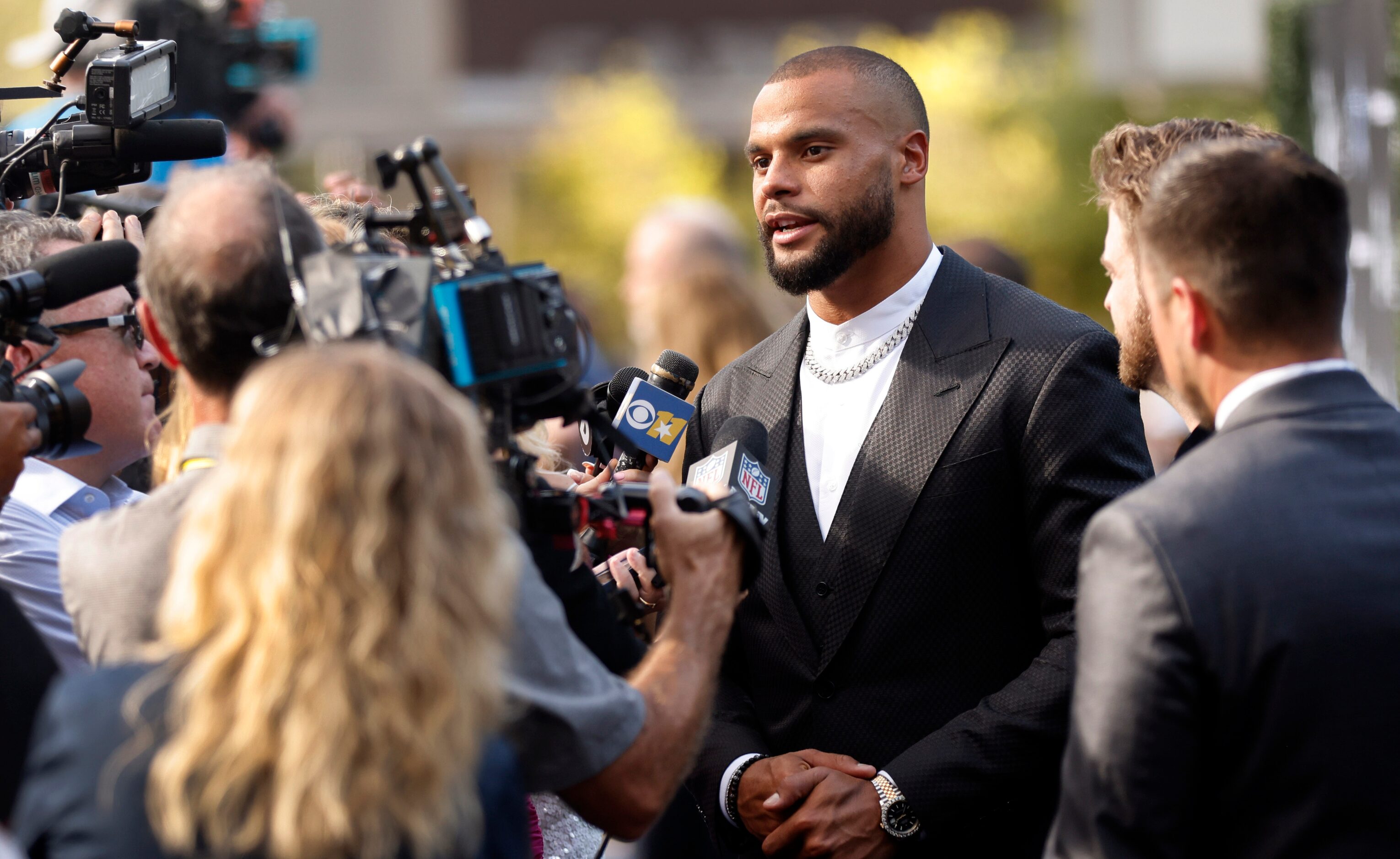 Dallas Cowboys quarterback Dak Prescott answers questions on the blue carpet as he arrives...