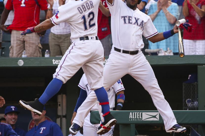 The Texas Rangers' Rougned Odor (12) celebrates his first-inning home run with Elvis Andrus...