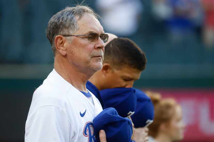Texas Rangers manager Bruce Bochy stands during the National Anthem before a baseball game...