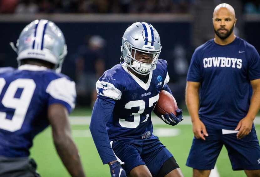 Dallas Cowboys defensive back Donovan Wilson (37) takes on cornerback Chris Westry (39)...