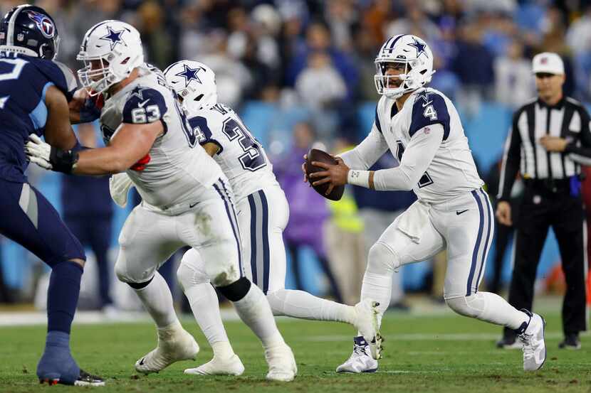 Dallas Cowboys quarterback Dak Prescott (4) takes the snap from center Tyler Biadasz (63)...