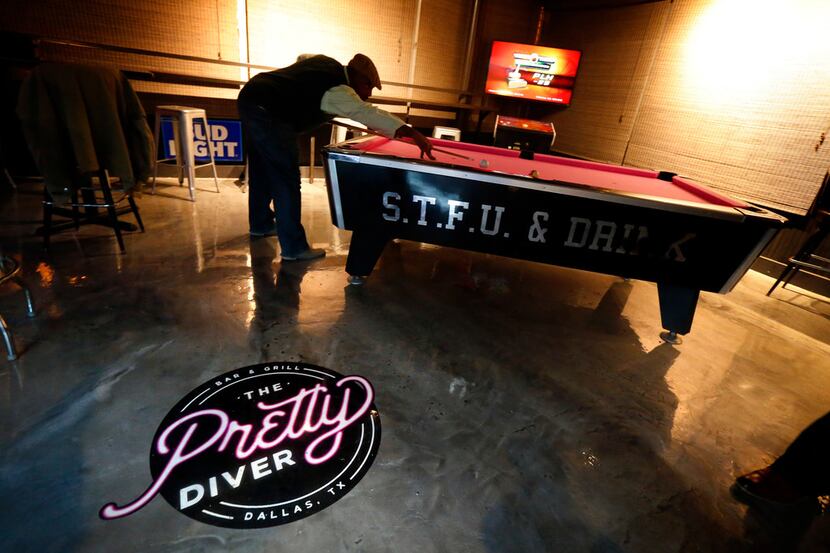 A gentleman plays pool at The Pretty Diver bar at 3030 Ross Ave. near downtown Dallas