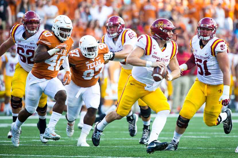 Texas' Naashon Hughes tries to run down Iowa State quarterback Joel Lanning, second from...