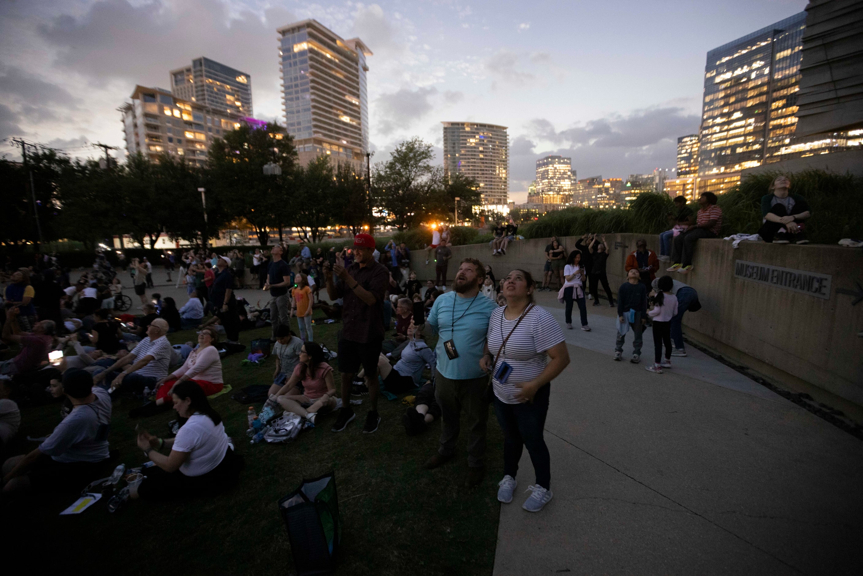 People watch the total eclipse during the Great North American Eclipse event at the Perot...