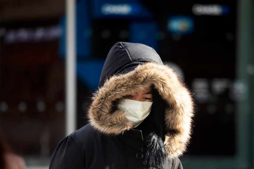 A woman wears a mask to guard against the new coronavirus Jan. 30 in New York City.