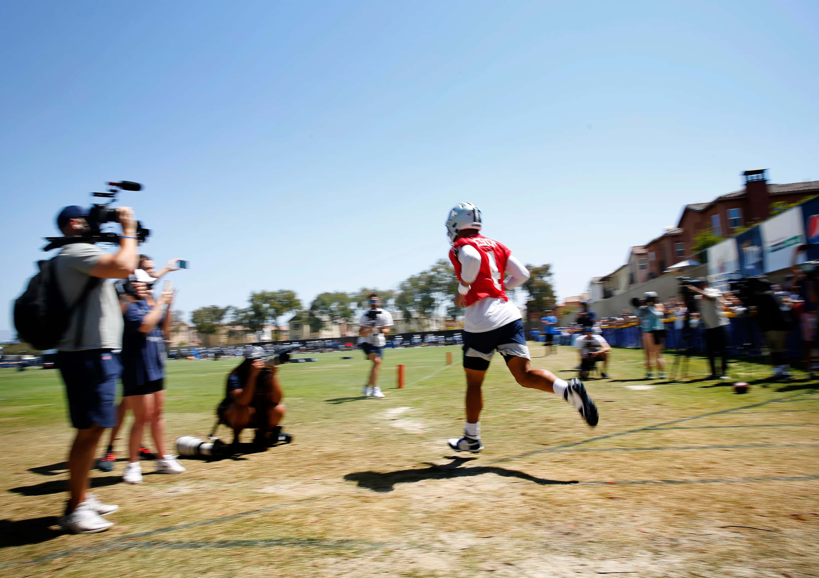 Dallas Cowboys quarterback Dak Prescott (4) jogs to the practice field for a Dallas Cowboys...
