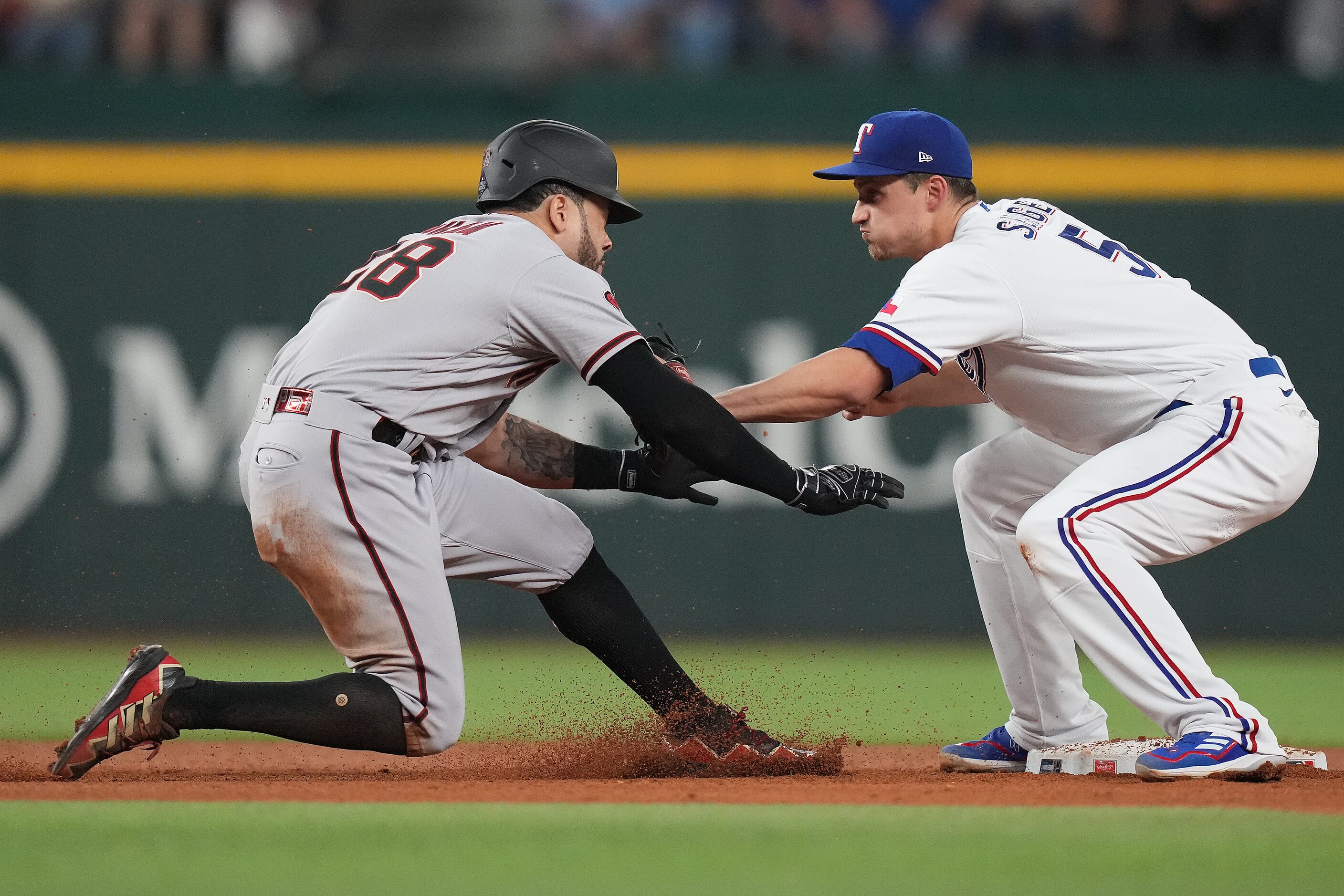 Arizona Diamondbacks designated hitter Tommy Pham (28) is picked off at second base by Texas...