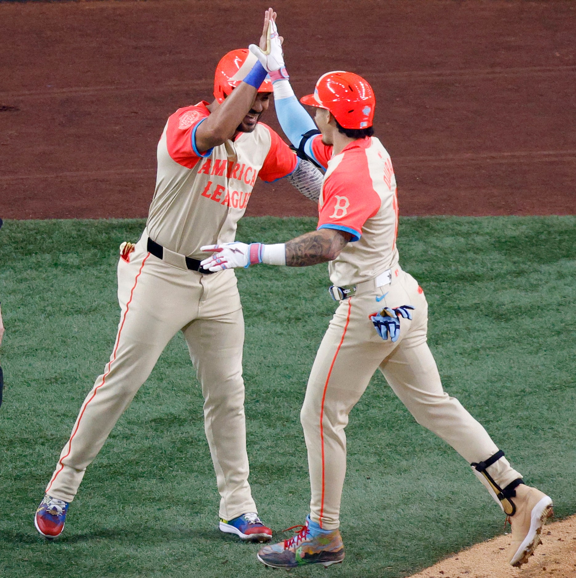 American League's Jarren Duran of Boston Red Sox (16), right, gets a high-five from his...