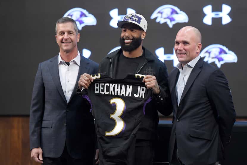 Recently signed Baltimore Ravens wide receiver Odell Beckham Jr., center, stands with head...