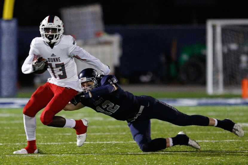 Bishop Dunne wide receiver Marquez Beason (13) evades a tackle against Argyle Liberty...