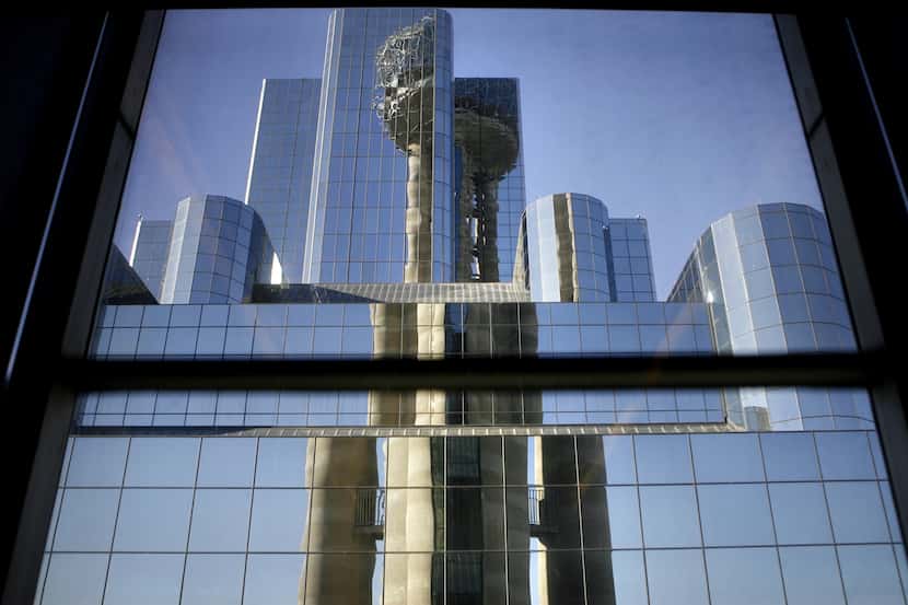 Reunion Tower is reflected in window panes of the Hyatt Regency hotel in downtown Dallas in...