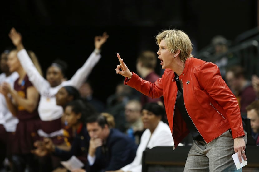Minnesota coach Marlene Stollings, right, calls to her team during the first half of a...