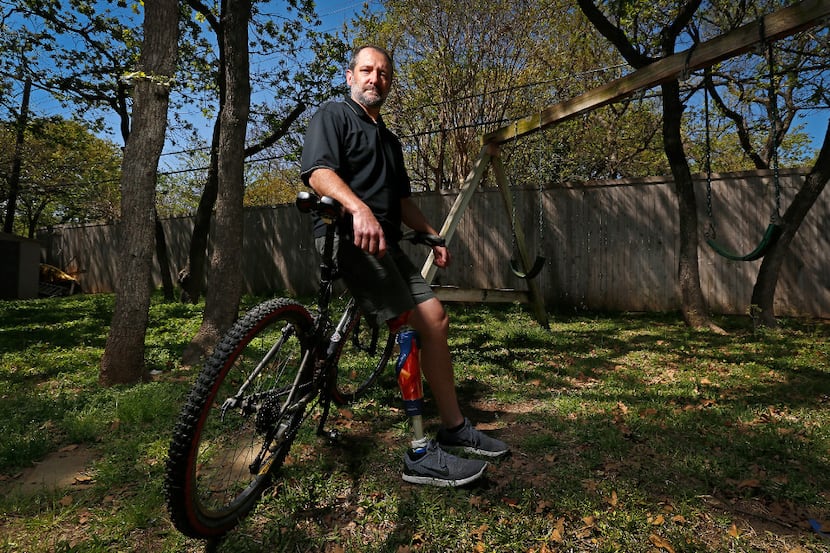 Michael Orlie sits on a mountain bike in the backyard of his home on Tuesday, March 21,...