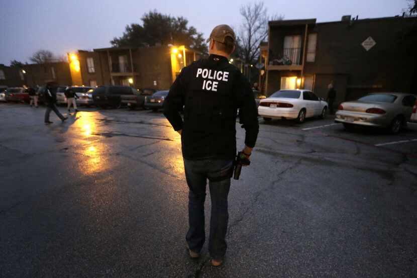 U.S. Immigration and Customs Enforcement agents enter a Dallas apartment complex earlier...