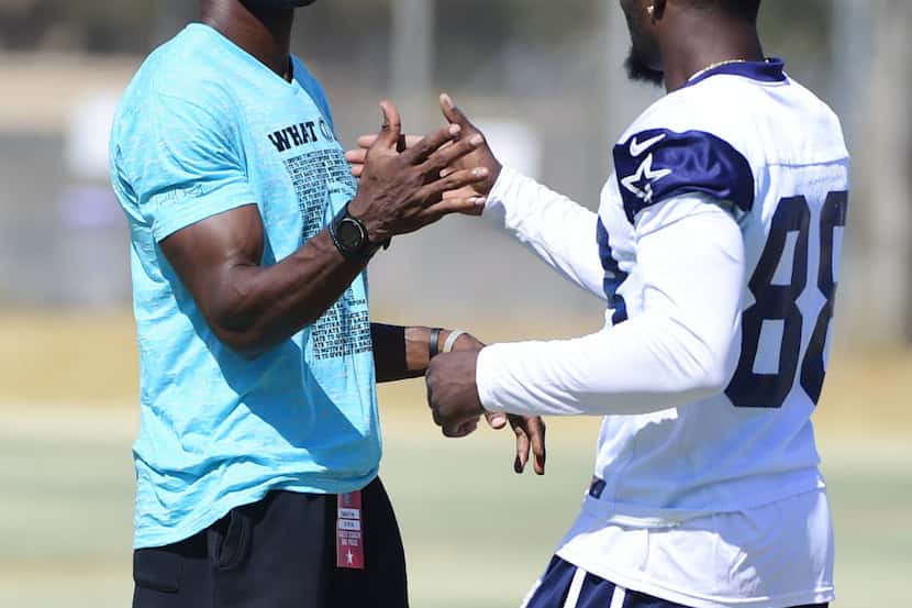 Former Dallas Cowboys receiver Terrell Owens greets  wide receiver Dez Bryant (88) during...