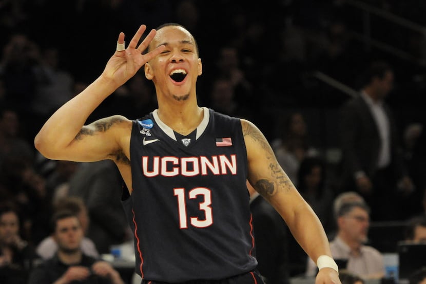 In the closing seconds of the game, Connecticut Huskies guard Shabazz Napier (13) celebrates...