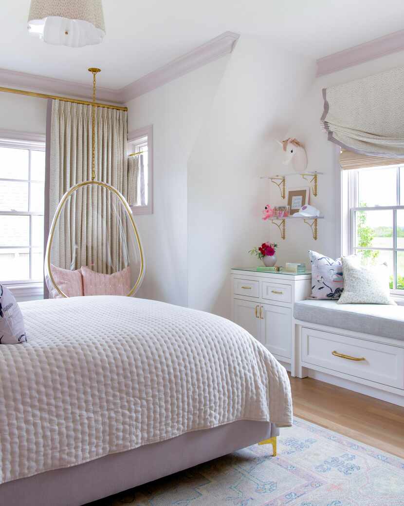 A white bedroom has purple trim and a bed with purple bedding.