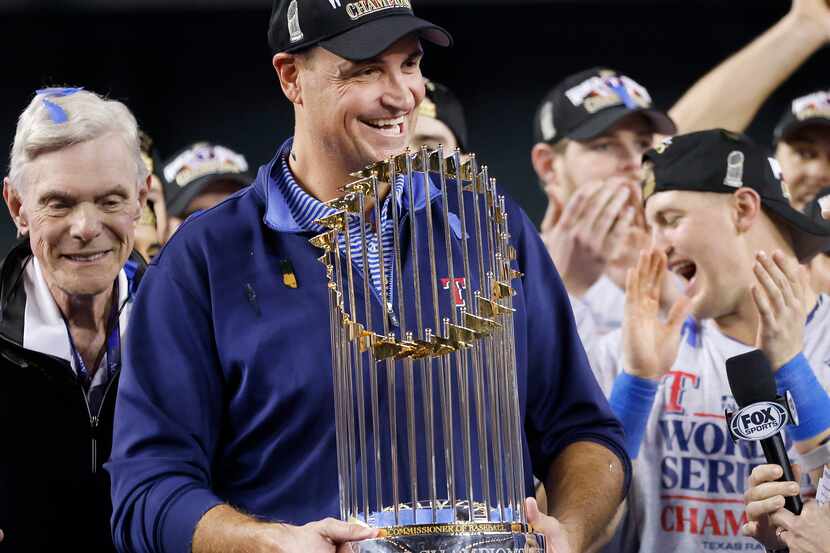 Texas Rangers general manager Chris Young is presented the World Series trophy during a...