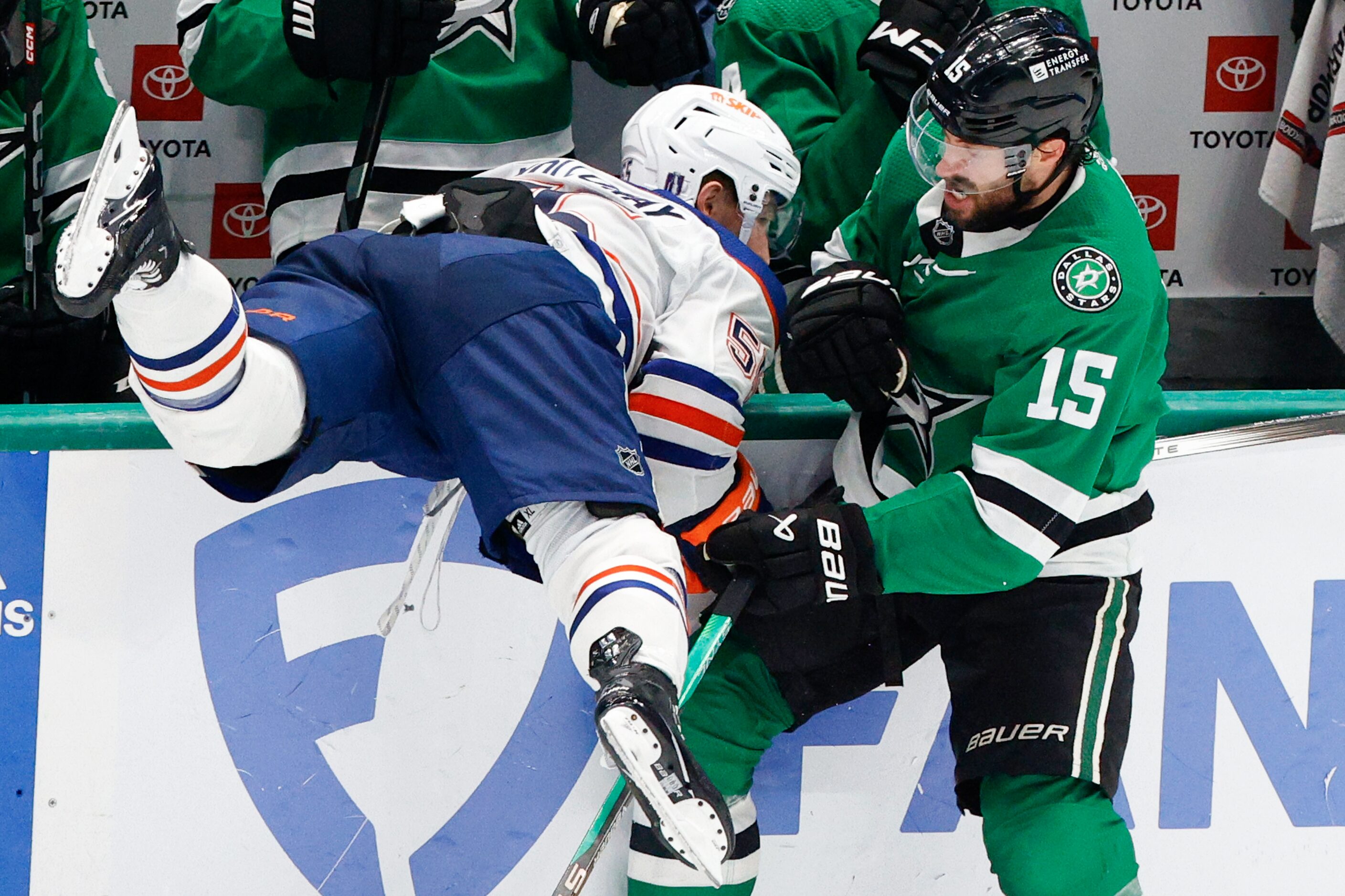 Dallas Stars center Craig Smith (15) checks Edmonton Oilers defenseman Cody Ceci (5)  in the...