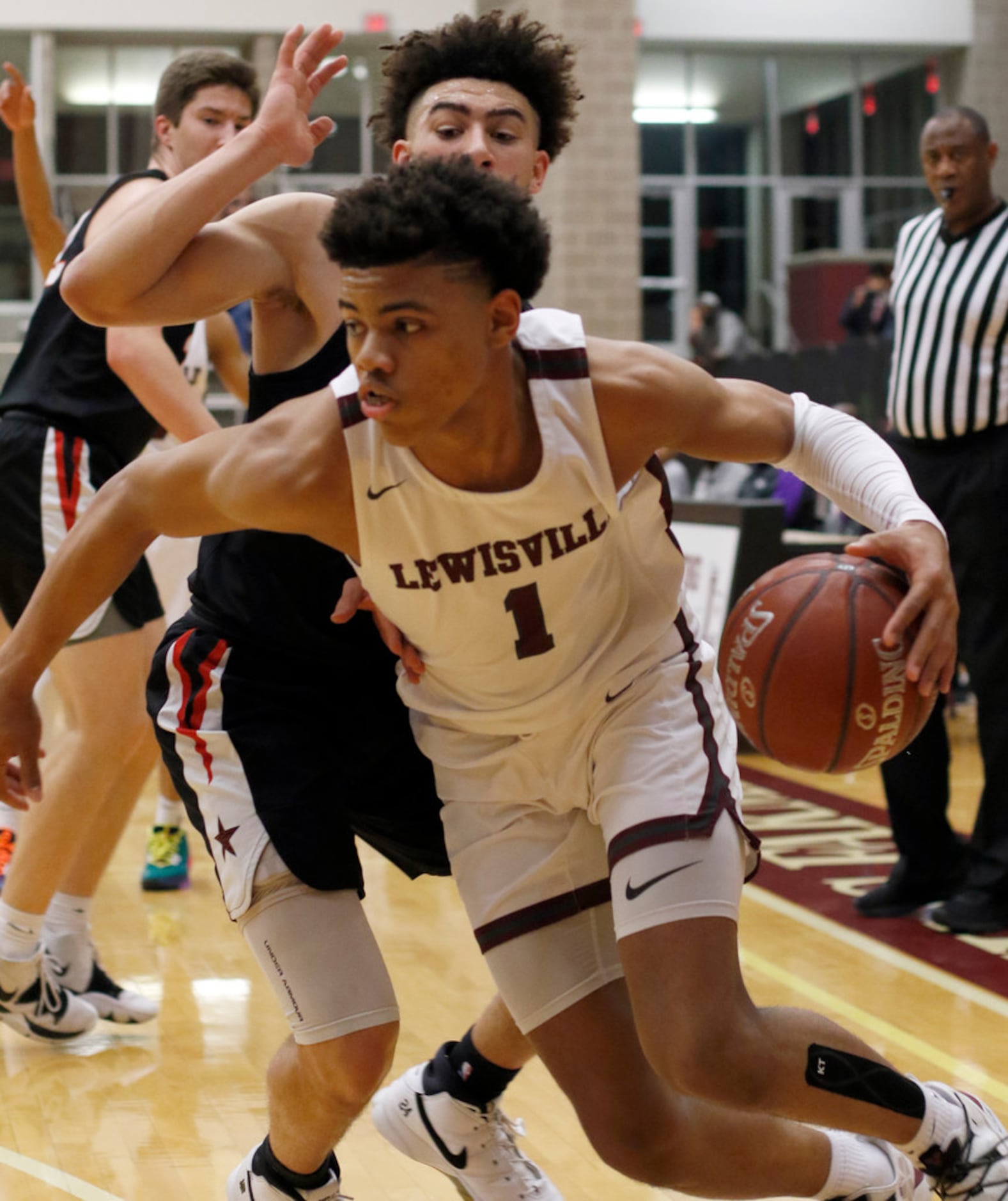 Lewisville's Keyonte George (1) drives the baseline past the defense of Coppell's Brandon...