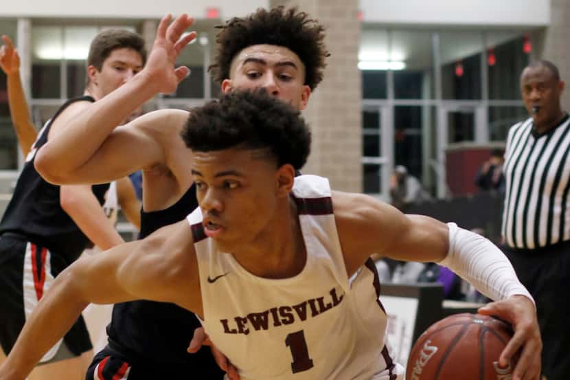 FILE - Lewisville's Keyonte George (1) drives the baseline past Coppell's Brandon Taylor (2)...