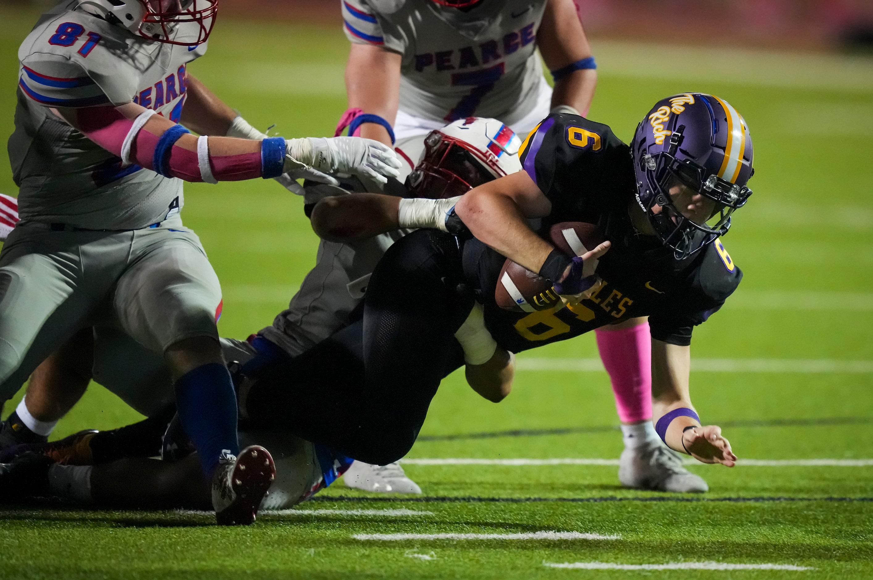 Richardson quarterback Cole Cage (6) is brought down by Richardson Pearce defensive lineman...