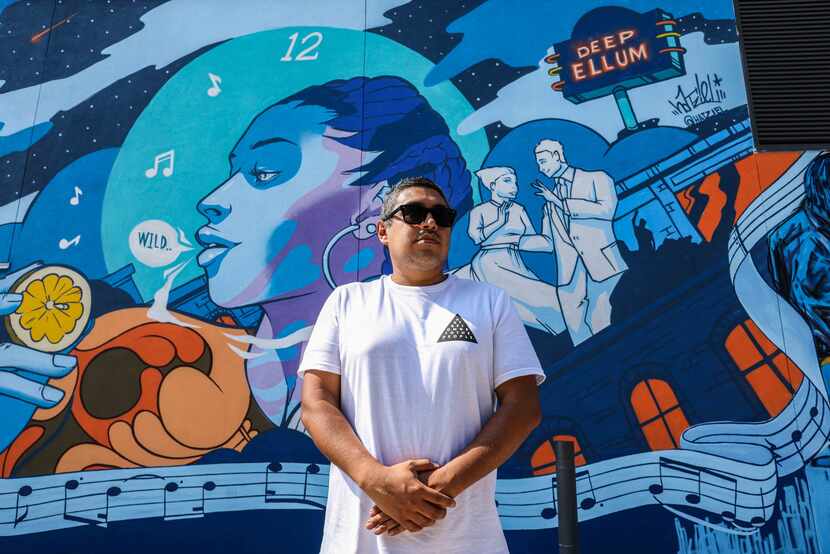 Hatziel Flores poses by his creation "Big Night Blues" in the alley.