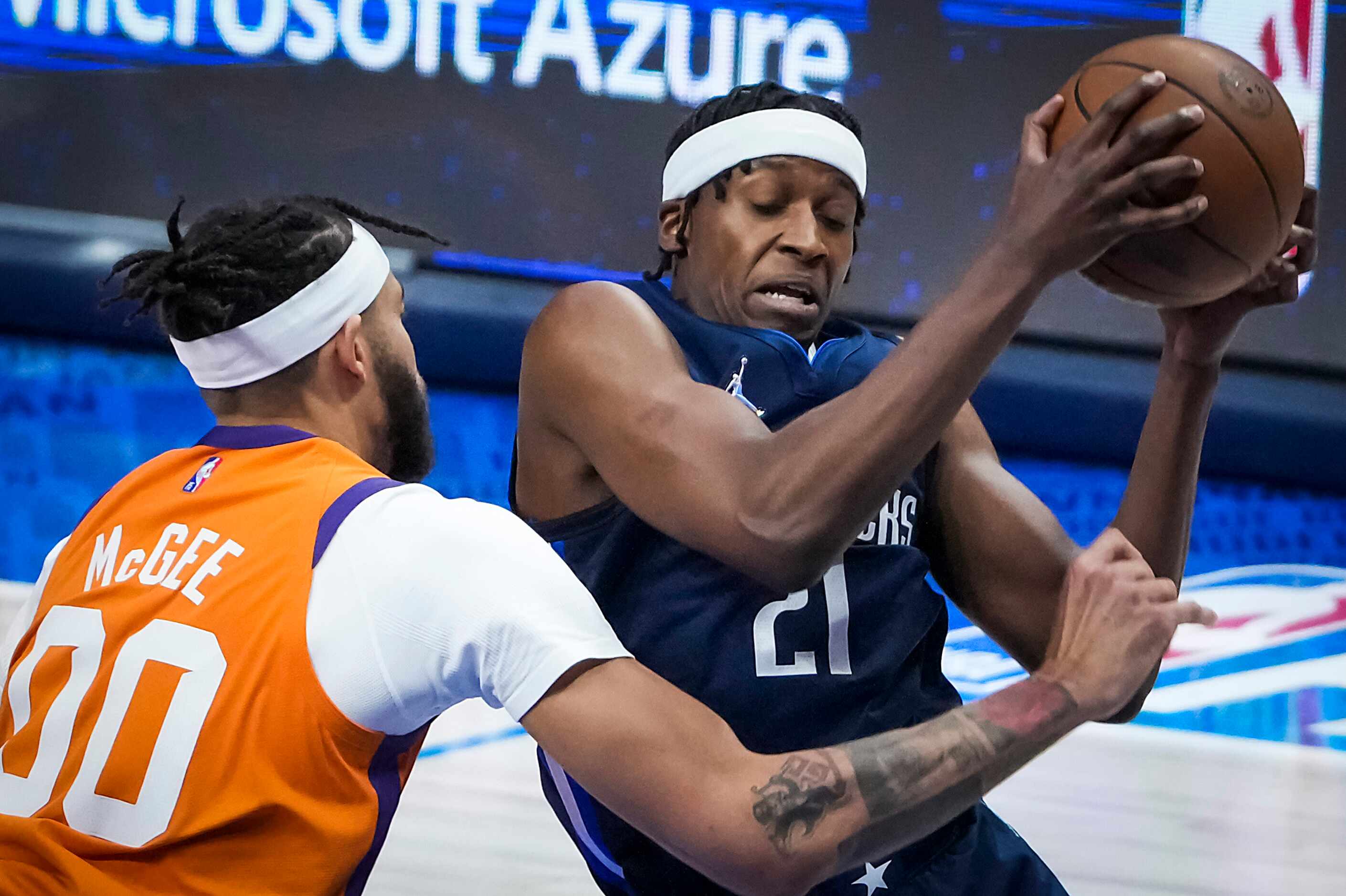 Dallas Mavericks guard Frank Ntilikina (21) is fouled by Phoenix Suns center JaVale McGee...