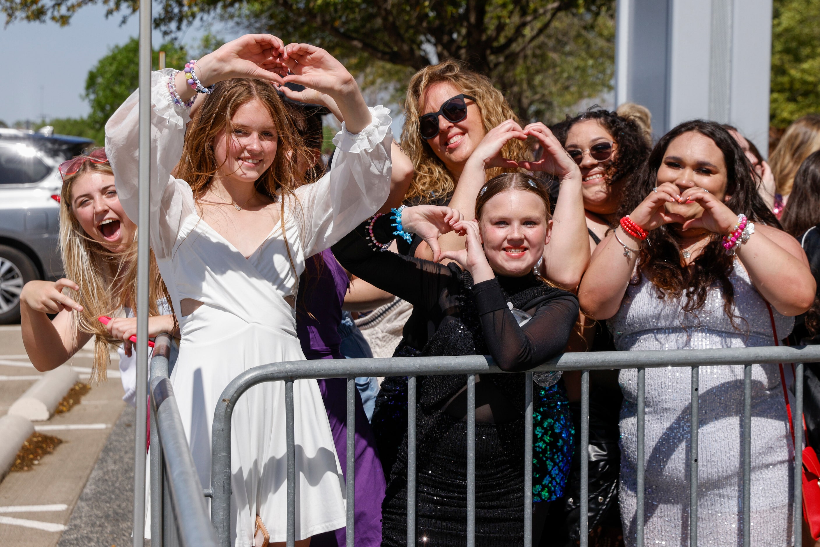 Taylor Swift fans pose for a photo before Swift’s Eras Tour concert at AT&T Stadium.