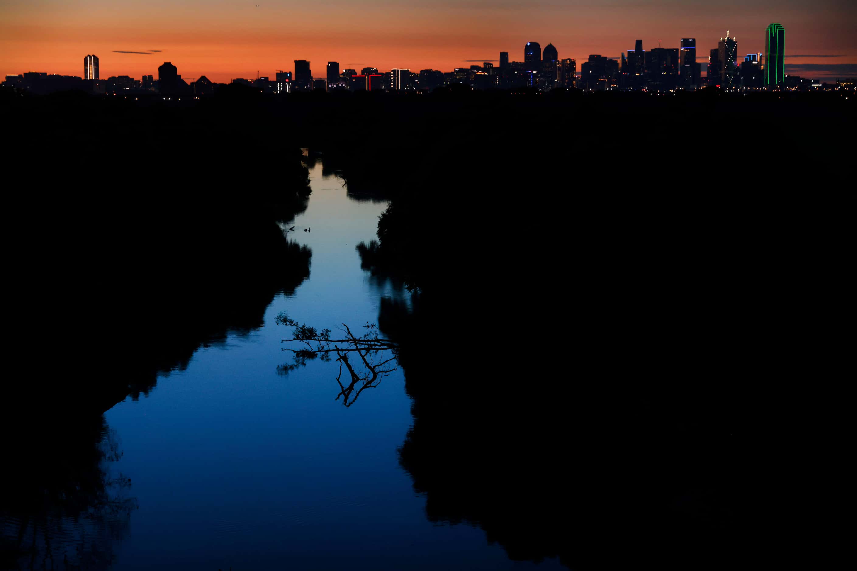 The sun rises over the Trinity River near the Westmoreland bridge early Monday morning,...