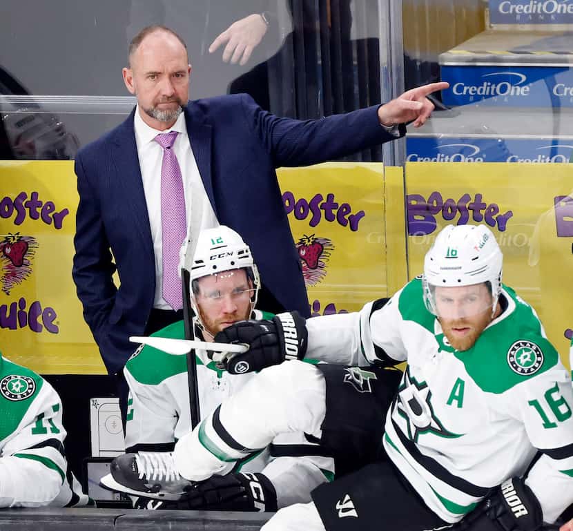 Dallas Stars head coach Peter DeBoer gives direction to the players during the first period...