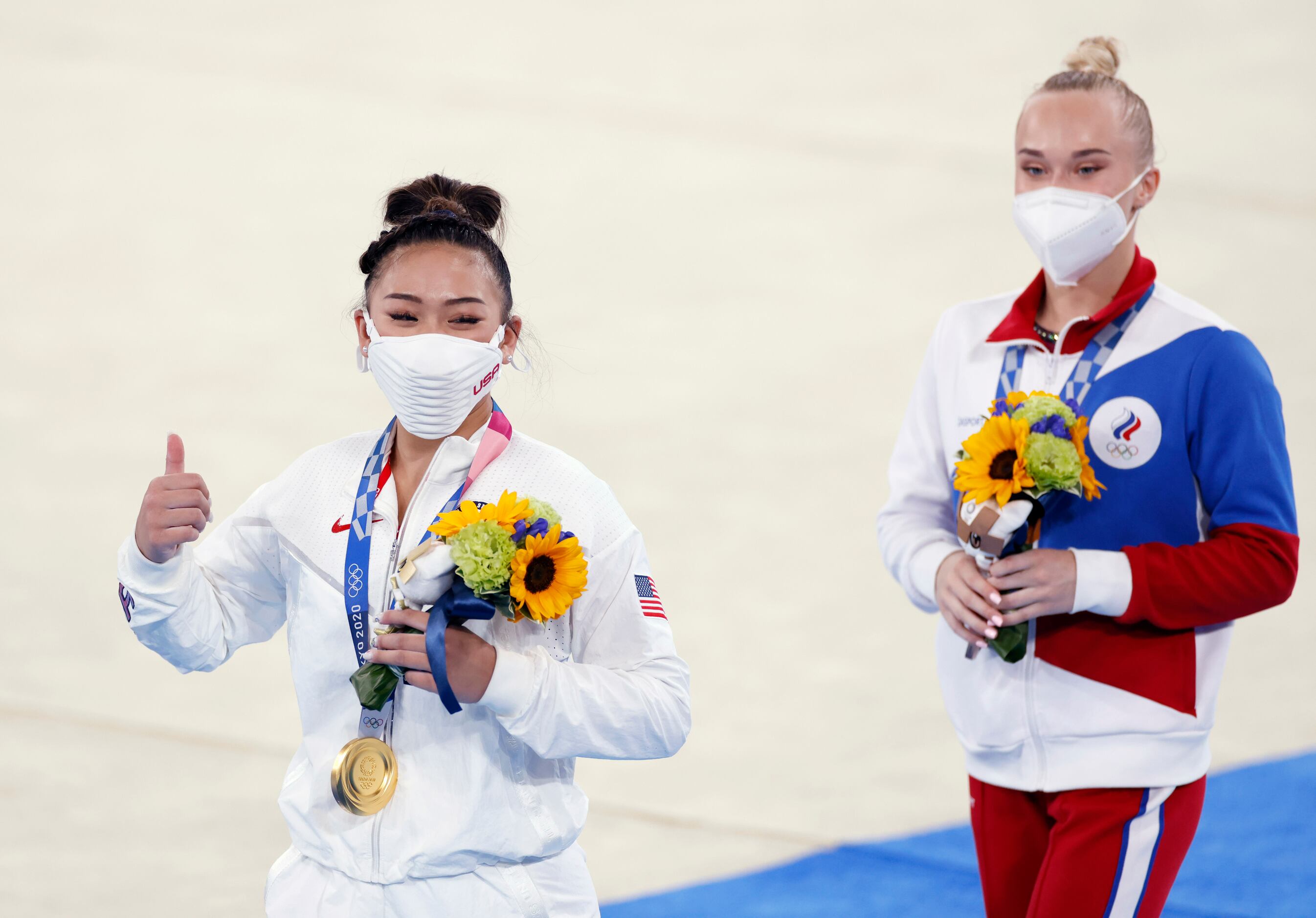 Gold medal winner USA’s Sunisa Lee, and bronze medal winner ROC’s Angelina Melnikova walk...