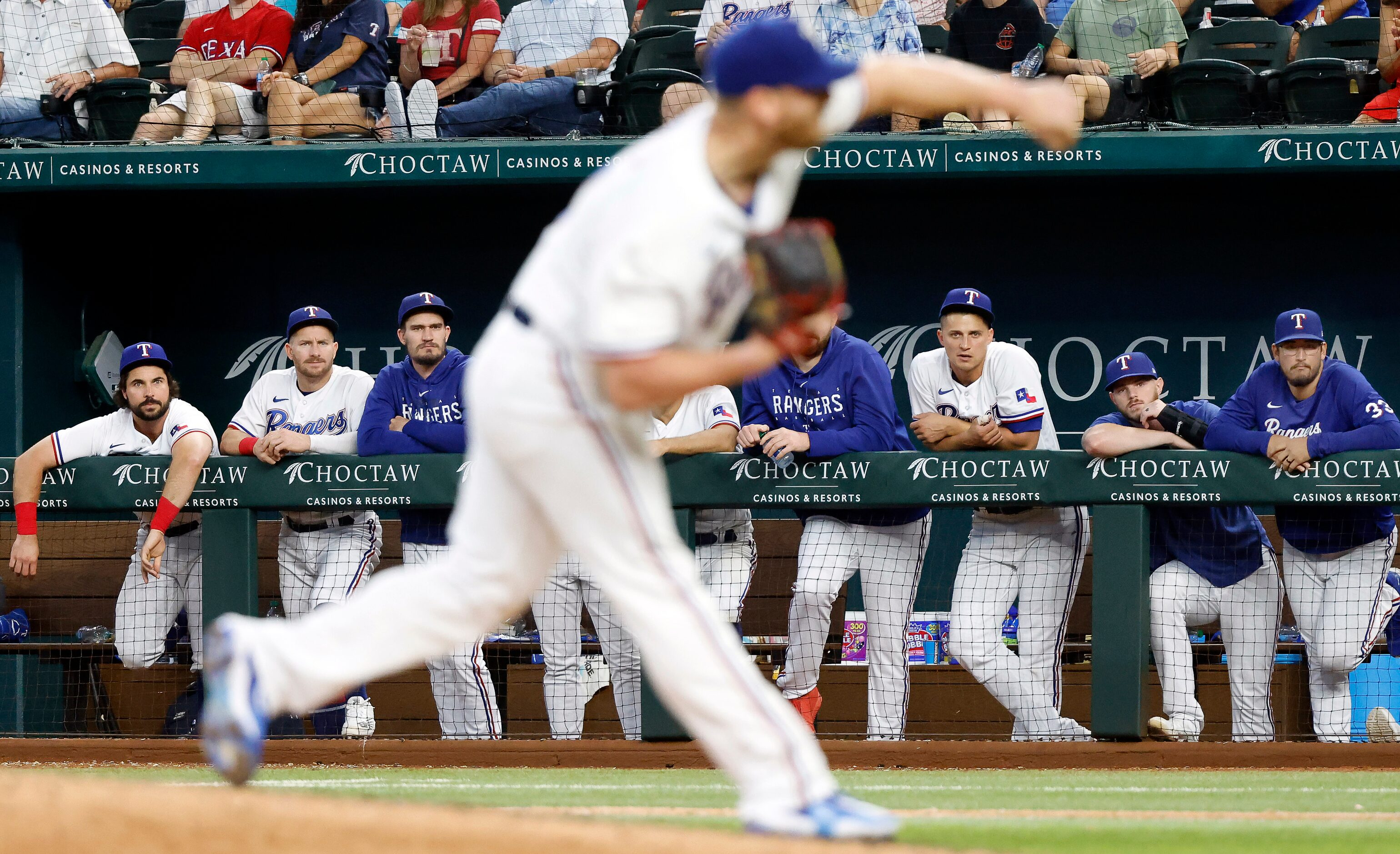 Texas Rangers players watch as relief pitcher Will Smith (51) closes out the ninth inning...