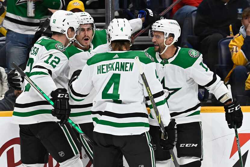 Dallas Stars left wing Mason Marchment, second from left, celebrates with teammates after...