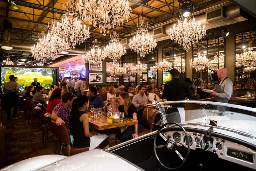 A yellow submarine aquarium, a Porsche, chandeliers and old photographs decorate the dining...
